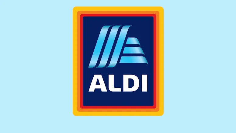 The image displays the Aldi logo, featuring a stylized blue "A" design with horizontal stripes on a dark blue background. The logo is framed by orange and golden-yellow borders. The background of the image is light blue.